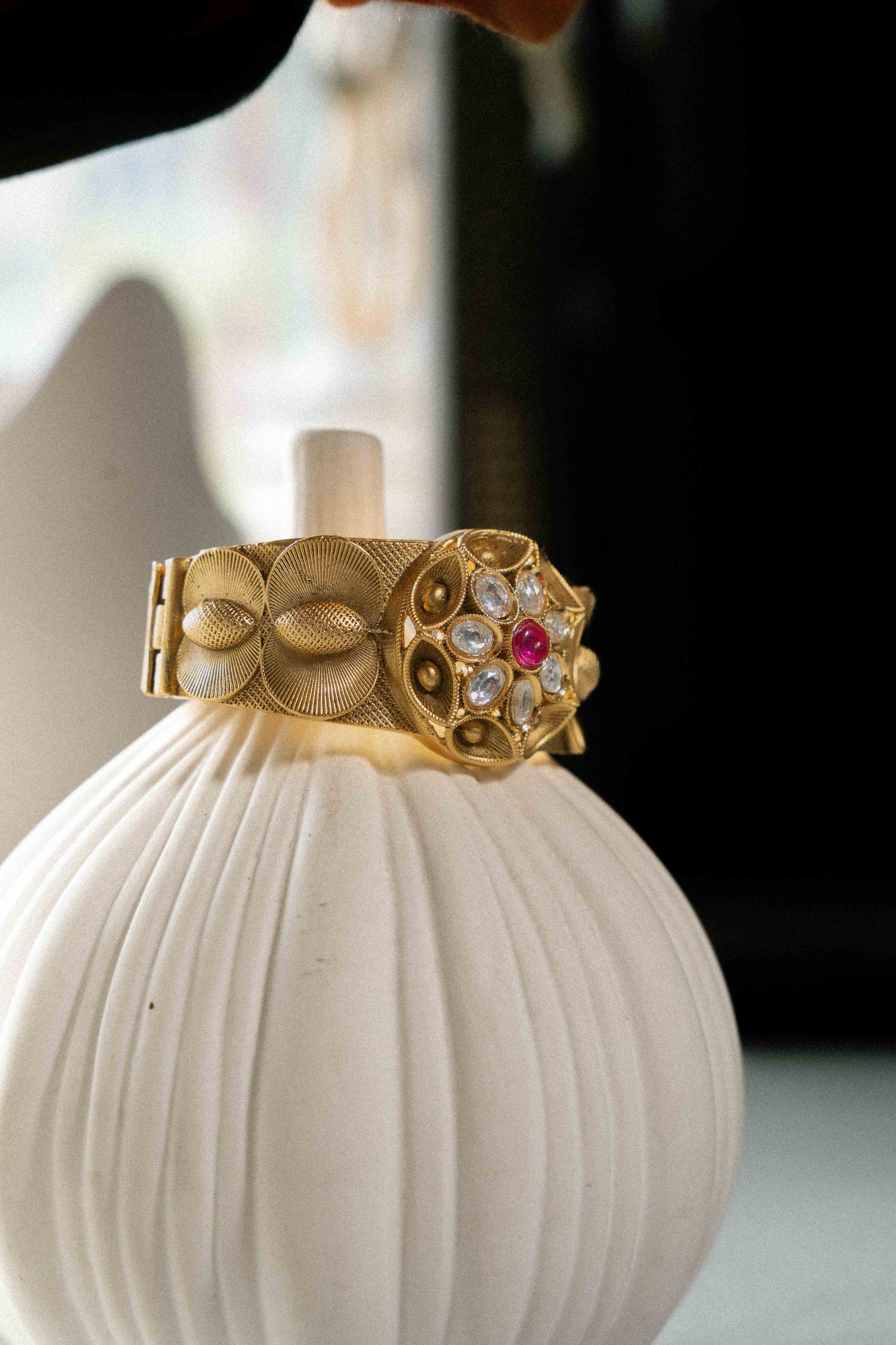 Regal Rose Bracelet by SAVIC — detail view of ruby and Kundan stonework on adjustable gold-plated band
